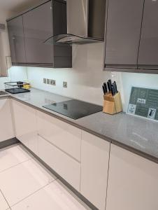 a kitchen with white cabinets and a counter top at Central Highland Escape in Caol