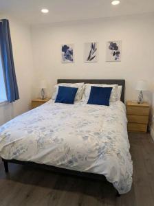 a bedroom with a large bed with blue pillows at Central Highland Escape in Caol