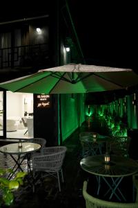 a restaurant with tables and chairs and an umbrella at EL hotel in Kutaisi