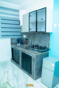 a kitchen with a sink and a counter top at La MAISON SEONE STANDARD in Abidjan