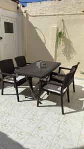 a picnic table and two chairs on a patio at Elia in Kalamoti +16 photos