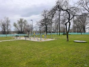 a park with a playground in the grass at Karina Maliuc Apartment in Maliuc