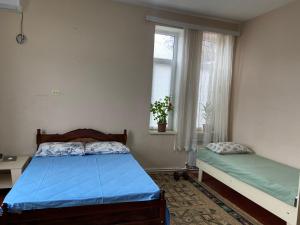 a bedroom with a blue bed and a window at Holiday home in Qusar +16 photos