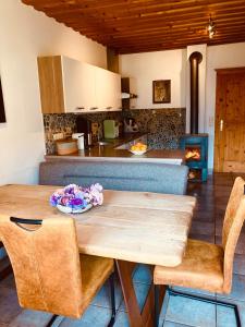 a kitchen with a wooden table and some chairs at Ferienwohnung Oberprossegg in Matrei in Osttirol