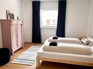 a bedroom with two beds and a window at Ferienwohnung IMMI in Ruhpolding