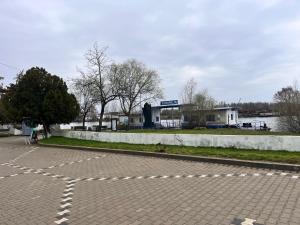 an empty parking lot with a building in the background at Karina Maliuc Apartment in Maliuc