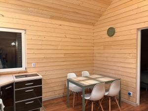 a dining room with a table and four chairs at Accommodation under the Oaks in Dramino +4 photos