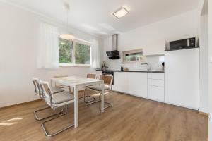 a kitchen and dining room with a table and chairs at Fine Stay Apartments in Žirovnica