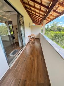 a room with a balcony with a table and a chair at Suítes Mazzioni in Socorro