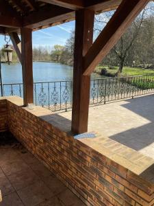a brick wall with a view of a river at Logement au bord de l eau in Dordives