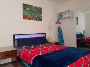 a bedroom with a bed and a painting on the wall at DePA DRAGON in Tizayuca