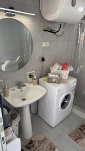 a bathroom with a washing machine and a sink at Elia in Kalamoti