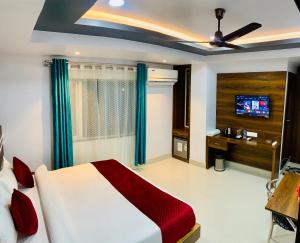 a bedroom with a bed and a television in it at Shanti Regency in Guwahati
