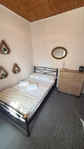 a bedroom with a bed and a mirror on the wall at Elia in Kalamoti