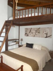 a bedroom with a large bed with a loft at La Casa del Coso in Peñafiel