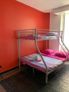 two bunk beds in a room with a red wall at capitol in Marseille