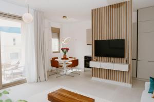 a living room with a television and a table at Bella Vista Residence with private Free Parking in Baošići