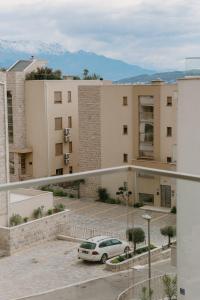 a car parked in a parking lot in front of a building at Bella Vista Residence with private Free Parking in Baošići