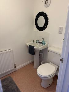 a bathroom with a toilet and a sink at The BILLINGFORD HORSESHOES in Scole +10 photos