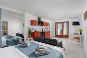a living room with two beds and a kitchen at Maestro Apartments Ičići Opatija Riviera in Ičići
