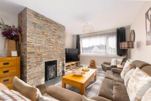 a living room with couches and a brick fireplace at Royal Apartment in Inverness