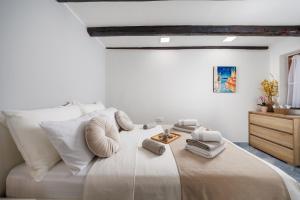 a bedroom with a large bed with white pillows at Maestro Apartments Ičići Opatija Riviera in Ičići