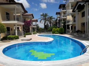 a swimming pool in front of some apartment buildings at Side Beach Villarında Dubleks Daire in Side