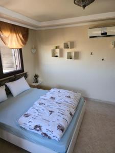 a bedroom with a bed with a blanket on it at Side Beach Villarında Dubleks Daire in Side +23 photos