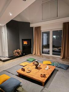 a living room with a table and a fireplace at AURA House in Krępa
