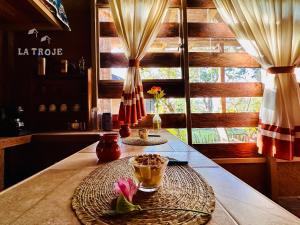 a table with a plate of food on it at La Troje Cabañas in Tepoztlán +11 photos