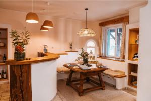 a kitchen with a wooden table and a counter at Almenlandhof in Fladnitz an der Teichalm