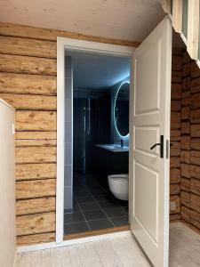 an open door to a bathroom with a toilet at Arctic Nest in Nyksund