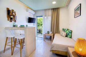 a living room with a couch and a table at Central Thassos luxury Apartment 4u in Limenas