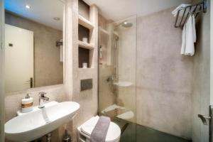 a bathroom with a sink and a toilet and a shower at Central Thassos luxury Apartment 4u in Limenas +4 photos