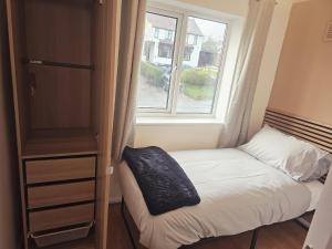 a small bedroom with a bed and a window at Valgor -3 Bedroom House-Sleeps 5 with free parking-Ideal for contractors, families and group stays-WV6 in Tettenhall