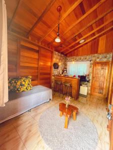 a bedroom with a bed and a table in a room at Pousada Casas Eleganza in Santa Teresa
