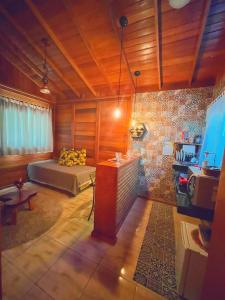 a bedroom with a bed and a table in it at Pousada Casas Eleganza in Santa Teresa