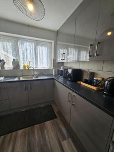 a kitchen with a sink and a counter top at Valgor -3 Bedroom House-Sleeps 5 with free parking-Ideal for contractors, families and group stays-WV6 in Tettenhall