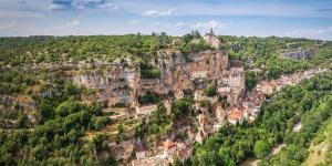 a town on the side of a mountain at Roulotte de cirque à Rocamadour in Rocamadour