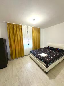 a bedroom with a bed and a large window at Residence 2 in Ploieşti