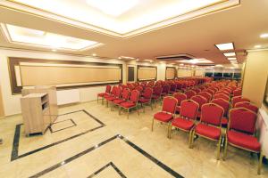 a conference room with red chairs and a podium at Atlıhanpark Hotel in Batman