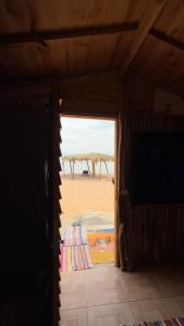 a room with a view of the beach through a doorway at Anne Nuweiba in Nuweiba