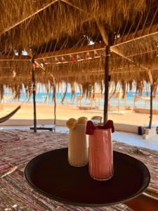 two salt and pepper shakers sitting on a table near the beach at Anne Nuweiba in Nuweiba