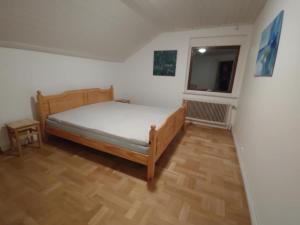 a bedroom with a bed and a window at Älgklinten with type 2 charger in Brograngen