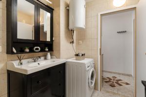 a bathroom with a sink and a washing machine at Maestro Apartments Ičići Opatija Riviera in Ičići +67 photos