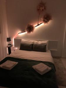 a bedroom with a bed with two towels on it at Aura in Kumanovo