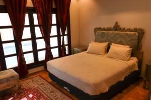 a bedroom with a bed and large windows at Lemon Tree Guest House in Riyadh +26 photos