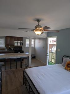 a bedroom with a bed and a ceiling fan at Trees Motel in Bishop