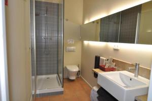 a bathroom with a sink and a shower and a toilet at Resataurant and Rooms Cabrit in Sant Mateu