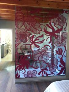 a room with a curtain with red flowers on it at Resataurant and Rooms Cabrit in Sant Mateu